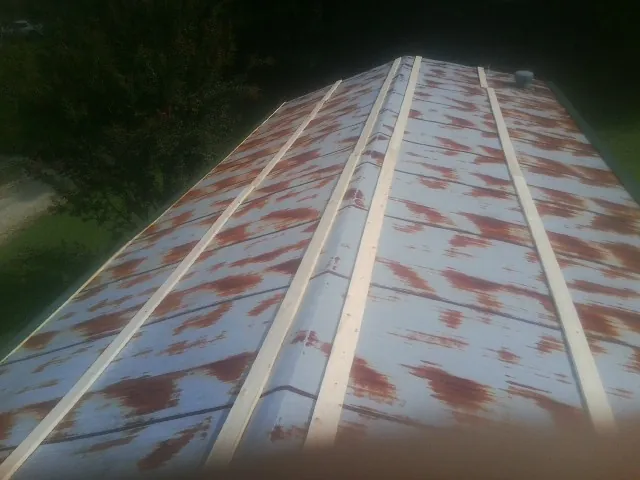 Rusted metal roof panels with new wood purlins before replacement — Storm Damage Roof Repair in Hyannis by Roofing Brothers